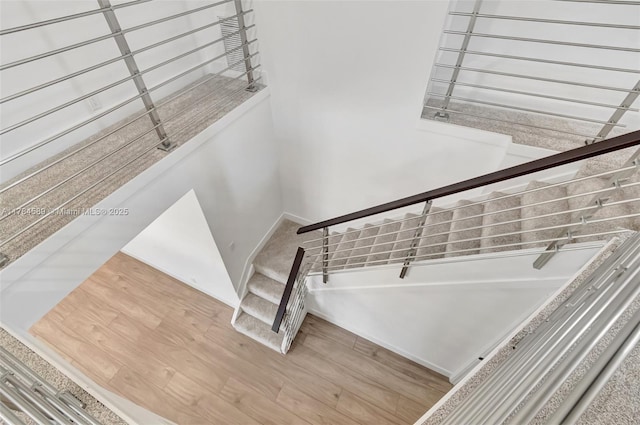 stairs featuring baseboards and wood finished floors