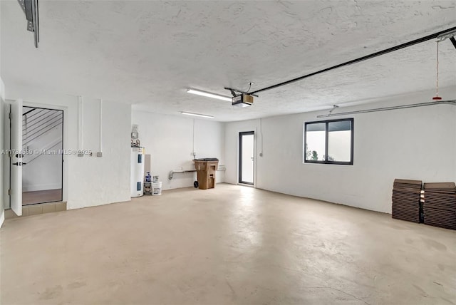 garage with a garage door opener and electric water heater