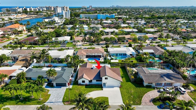 drone / aerial view with a residential view and a water view
