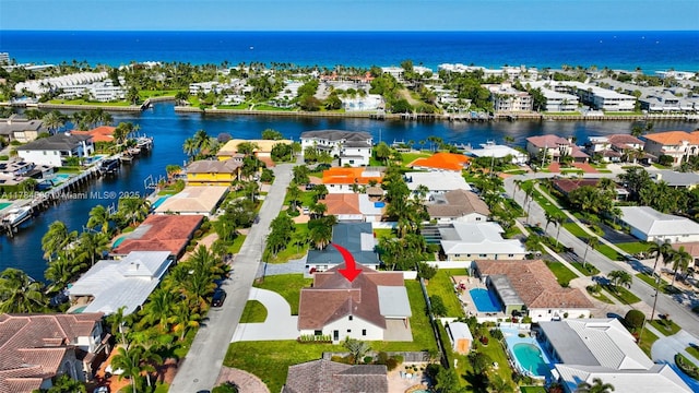 birds eye view of property with a residential view and a water view