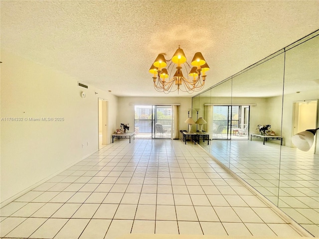 2334 S Cypress Bend Dr Unit 505, Pompano Beach, FL 33069 - unfurnished room with an inviting chandelier, a textured ceiling, and light tile patterned floors