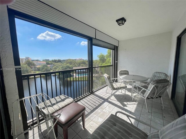2334 S Cypress Bend Dr Unit 505, Pompano Beach, FL 33069 - sunroom featuring outdoor dining area and a water view