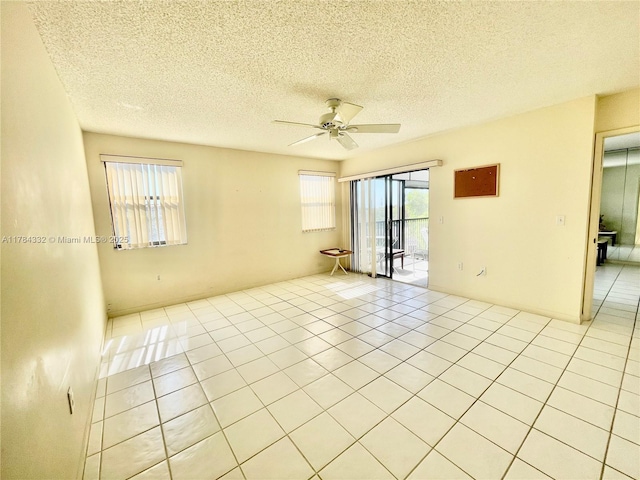 2334 S Cypress Bend Dr Unit 505, Pompano Beach, FL 33069 - empty room featuring a textured ceiling, ceiling fan, and light tile patterned floors