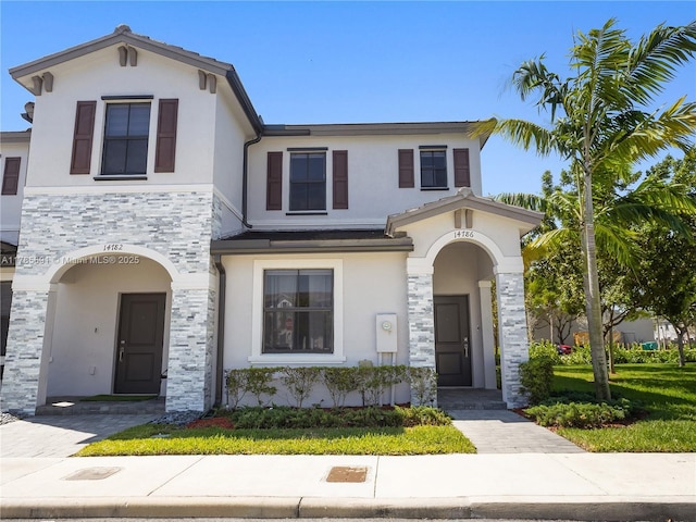 view of front of property with stucco siding and stone siding