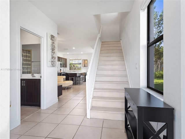 stairway with tile patterned flooring and recessed lighting