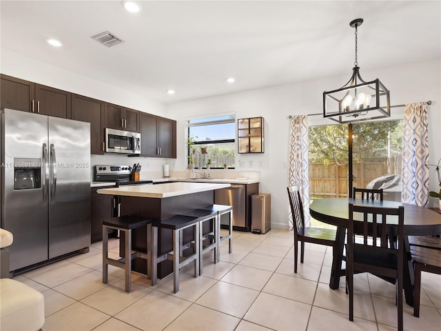 kitchen with a center island, visible vents, a notable chandelier, light countertops, and appliances with stainless steel finishes