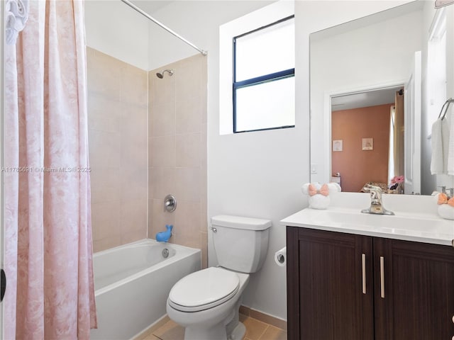 full bathroom featuring tile patterned floors, shower / bath combo with shower curtain, vanity, and toilet