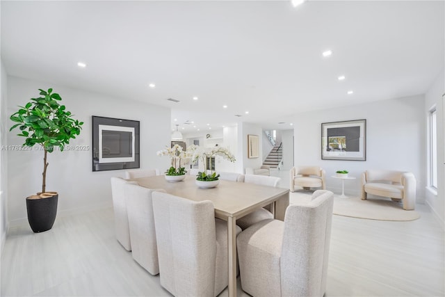 dining room featuring stairs, baseboards, and recessed lighting