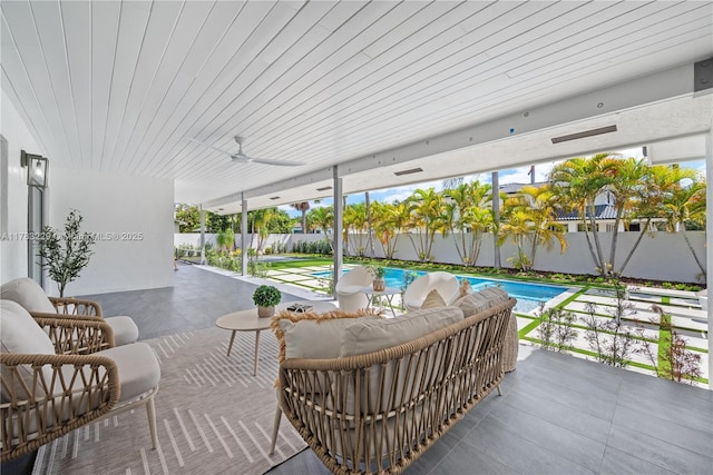 fenced backyard featuring a patio area and ceiling fan