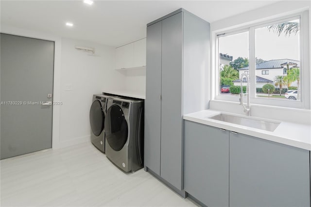 washroom featuring cabinet space, washer and dryer, recessed lighting, and baseboards