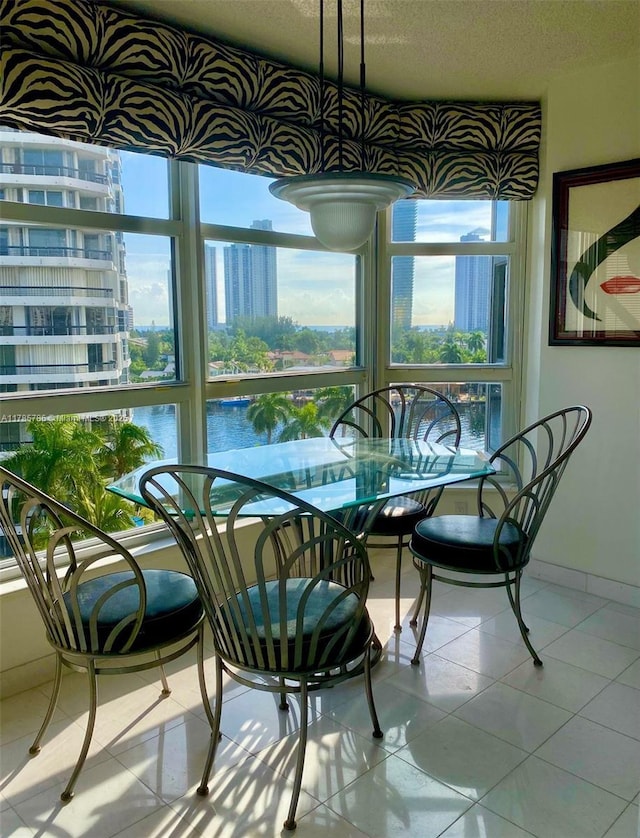 19101 NE 36th Ct Unit 807, Aventura, FL 33180 - dining room with tile patterned flooring and a textured ceiling