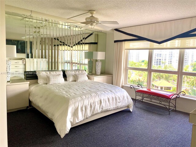 19101 NE 36th Ct Unit 807, Aventura, FL 33180 - bedroom featuring ceiling fan, multiple windows, and a textured ceiling