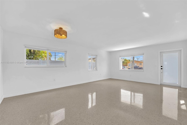 unfurnished living room featuring a wealth of natural light