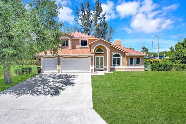 11201 SW 1st St, Plantation, FL 33325 - mediterranean / spanish-style home featuring a standing seam roof, driveway, french doors, a front yard, and metal roof