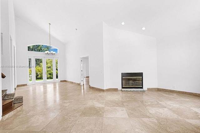 11201 SW 1st St, Plantation, FL 33325 - unfurnished living room with french doors, baseboards, a glass covered fireplace, recessed lighting, and high vaulted ceiling