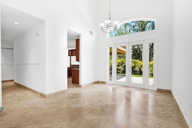 11201 SW 1st St, Plantation, FL 33325 - empty room with french doors, baseboards, a high ceiling, a notable chandelier, and visible vents