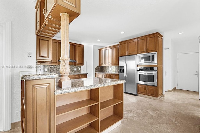 11201 SW 1st St, Plantation, FL 33325 - kitchen featuring stainless steel appliances, a peninsula, light stone counters, and tasteful backsplash