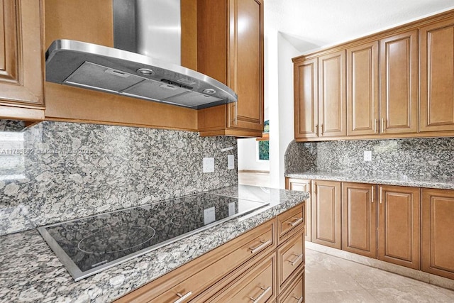 11201 SW 1st St, Plantation, FL 33325 - kitchen featuring black electric cooktop, brown cabinetry, range hood, and tasteful backsplash