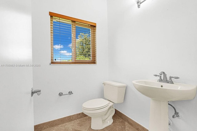 11201 SW 1st St, Plantation, FL 33325 - half bathroom featuring baseboards, a sink, and toilet