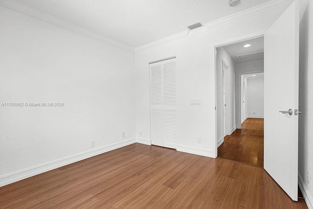 11201 SW 1st St, Plantation, FL 33325 - unfurnished bedroom with wood finished floors, visible vents, ornamental molding, a closet, and baseboards
