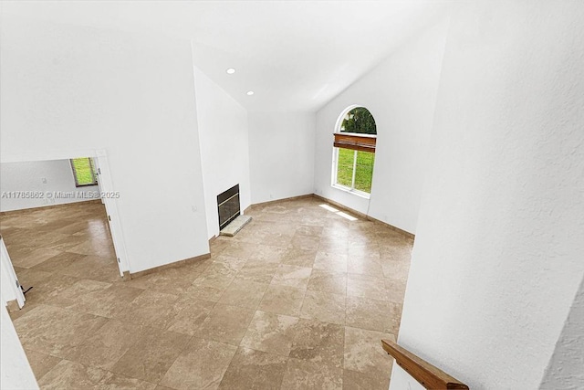 11201 SW 1st St, Plantation, FL 33325 - spare room featuring visible vents, baseboards, vaulted ceiling, and a glass covered fireplace
