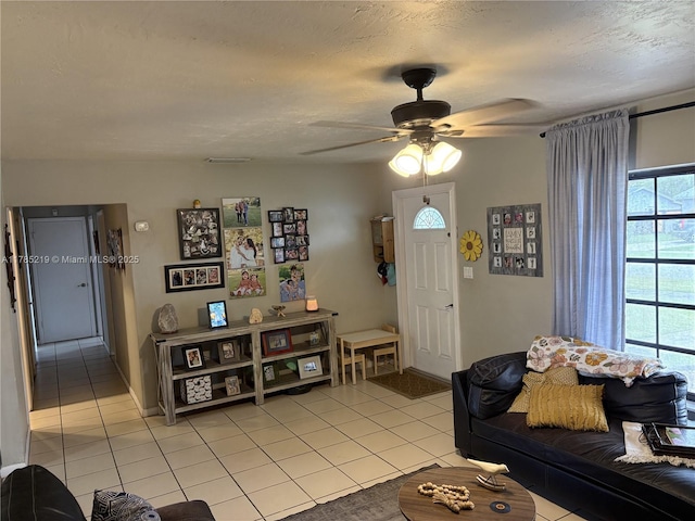 12021 SW 119th St, Miami, FL 33186 - living area featuring light tile patterned floors, a ceiling fan, and a textured ceiling