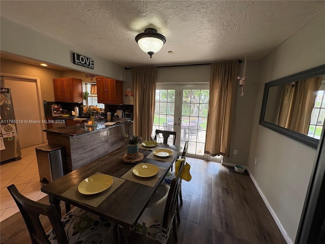 12021 SW 119th St, Miami, FL 33186 - dining area with french doors, a textured ceiling, and wood finished floors