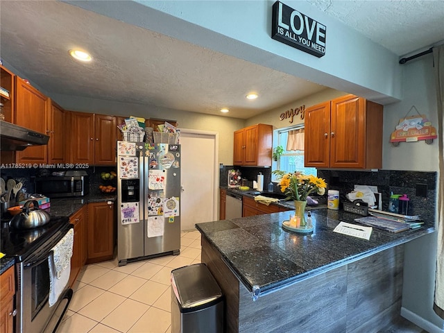 12021 SW 119th St, Miami, FL 33186 - kitchen featuring appliances with stainless steel finishes, a peninsula, tasteful backsplash, under cabinet range hood, and a textured ceiling