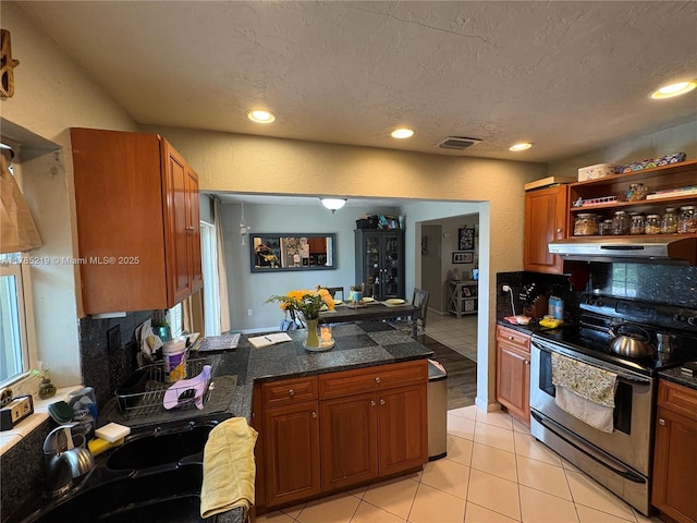 12021 SW 119th St, Miami, FL 33186 - kitchen with stainless steel range with electric cooktop, exhaust hood, a peninsula, open shelves, and brown cabinetry
