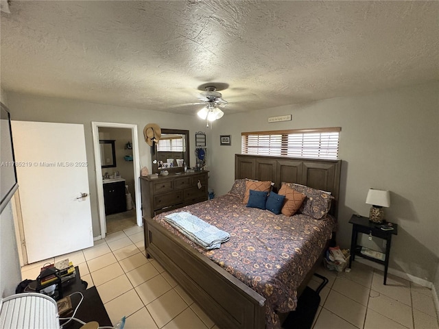 12021 SW 119th St, Miami, FL 33186 - bedroom with light tile patterned floors, ceiling fan, a textured ceiling, and connected bathroom
