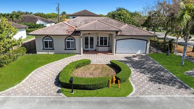 view of front facade featuring a front lawn, a tiled roof, an attached garage, stucco siding, and decorative driveway
