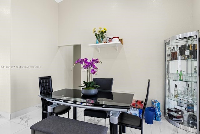 dining room featuring marble finish floor