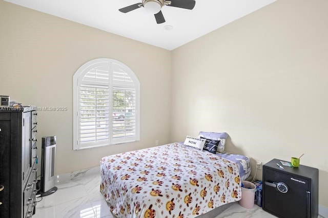 bedroom with marble finish floor and a ceiling fan