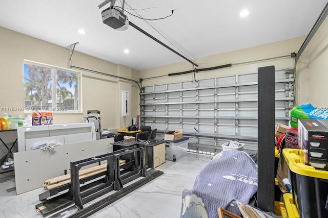 garage with recessed lighting and a garage door opener