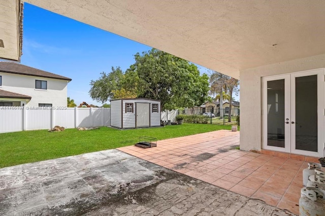 view of patio / terrace featuring an outdoor structure, french doors, a shed, and a fenced backyard
