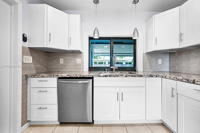 kitchen with white cabinets, dark stone counters, a sink, and dishwasher