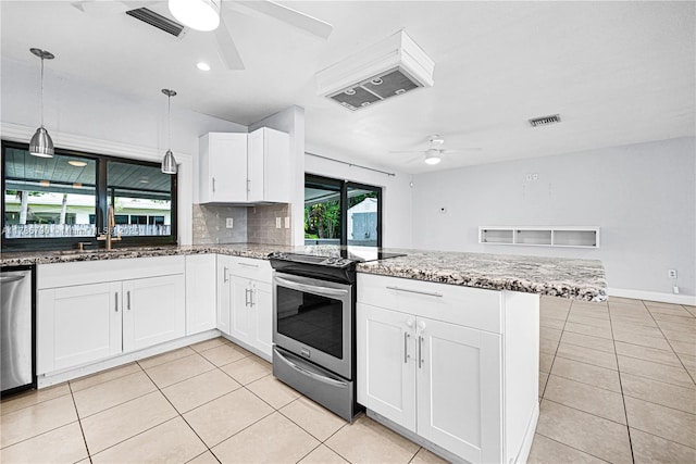 kitchen featuring a peninsula, visible vents, ceiling fan, appliances with stainless steel finishes, and light tile patterned flooring
