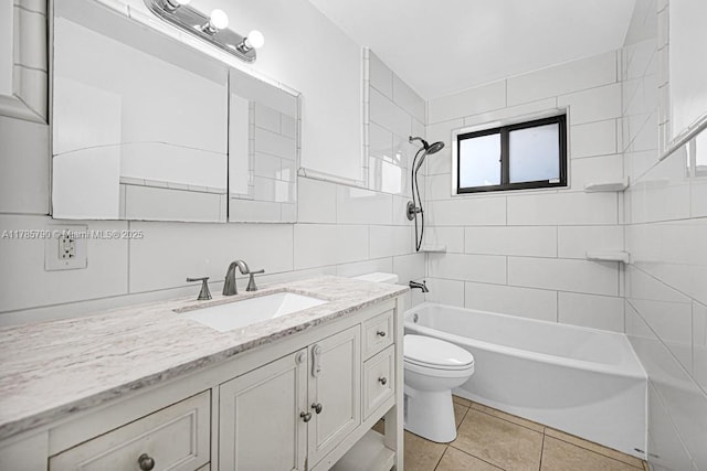full bath with toilet, tub / shower combination, tile walls, tile patterned flooring, and vanity