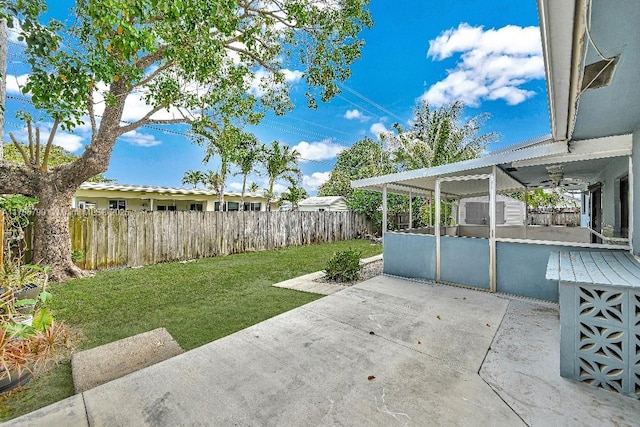 view of yard featuring a fenced backyard, a patio area, an outdoor structure, and a storage shed