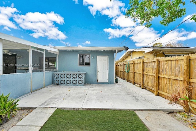 back of property featuring a patio, stucco siding, and fence