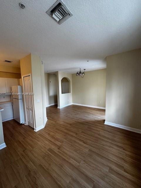 1017 Shoma Dr Unit 462, Royal Palm Beach, FL 33414 - unfurnished living room with baseboards, dark wood-type flooring, visible vents, and a chandelier
