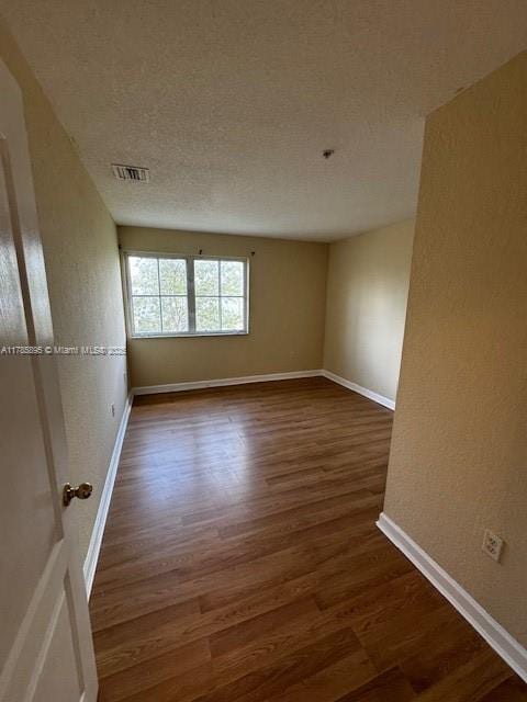 1017 Shoma Dr Unit 462, Royal Palm Beach, FL 33414 - spare room featuring baseboards, visible vents, and dark wood-style floors
