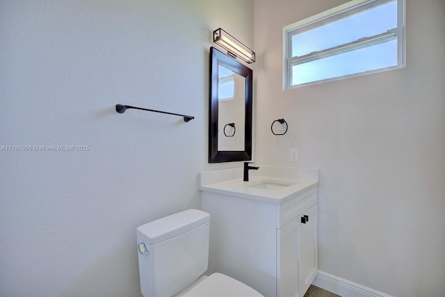 half bathroom with toilet and vanity