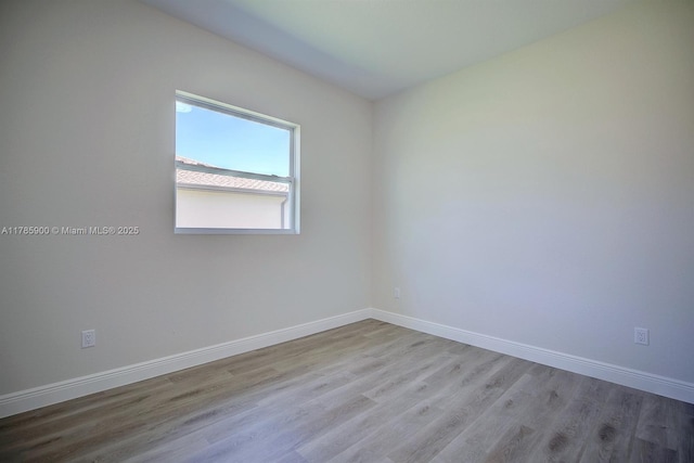 unfurnished room with light wood finished floors and baseboards