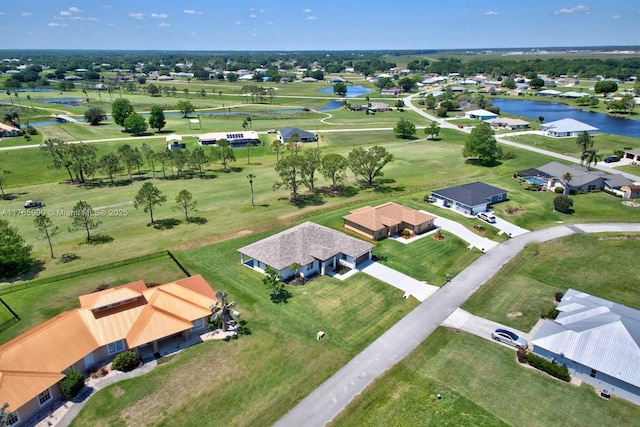 bird's eye view featuring a water view and a residential view