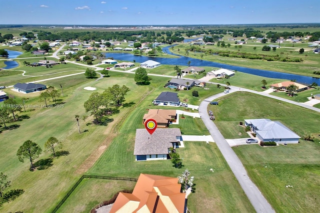 drone / aerial view featuring a residential view and a water view
