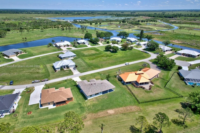 drone / aerial view featuring a residential view and a water view