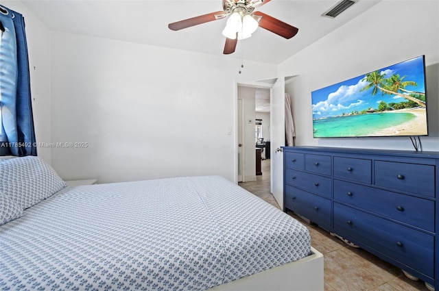 bedroom featuring visible vents, a ceiling fan, and light tile patterned floors