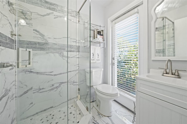 bathroom featuring marble finish floor, a wealth of natural light, a marble finish shower, and toilet