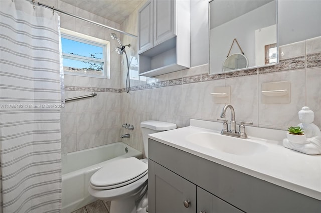full bath featuring tile walls, shower / bath combo with shower curtain, toilet, and vanity